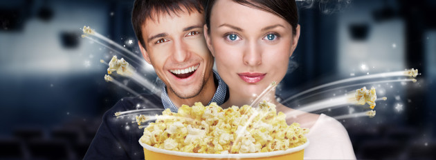 Portrait of young stylish modern couple watching movie at cinema